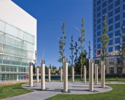 Aiko Miyawaki created a set of twelve ten-foot columns in an elliptical configuration with chromium-plated steel “threads” intertwining in graceful patterns from the top of each column. On the interior surface of each column, a small rectangle displays a glossy relief image depicting one of twelve animals of the Chinese zodiac, each identified in Latin and Chinese. Utsurohi means swift change.